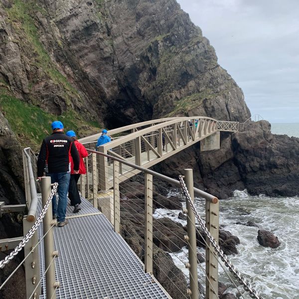 Tom and beth walking across long and narrow bridge